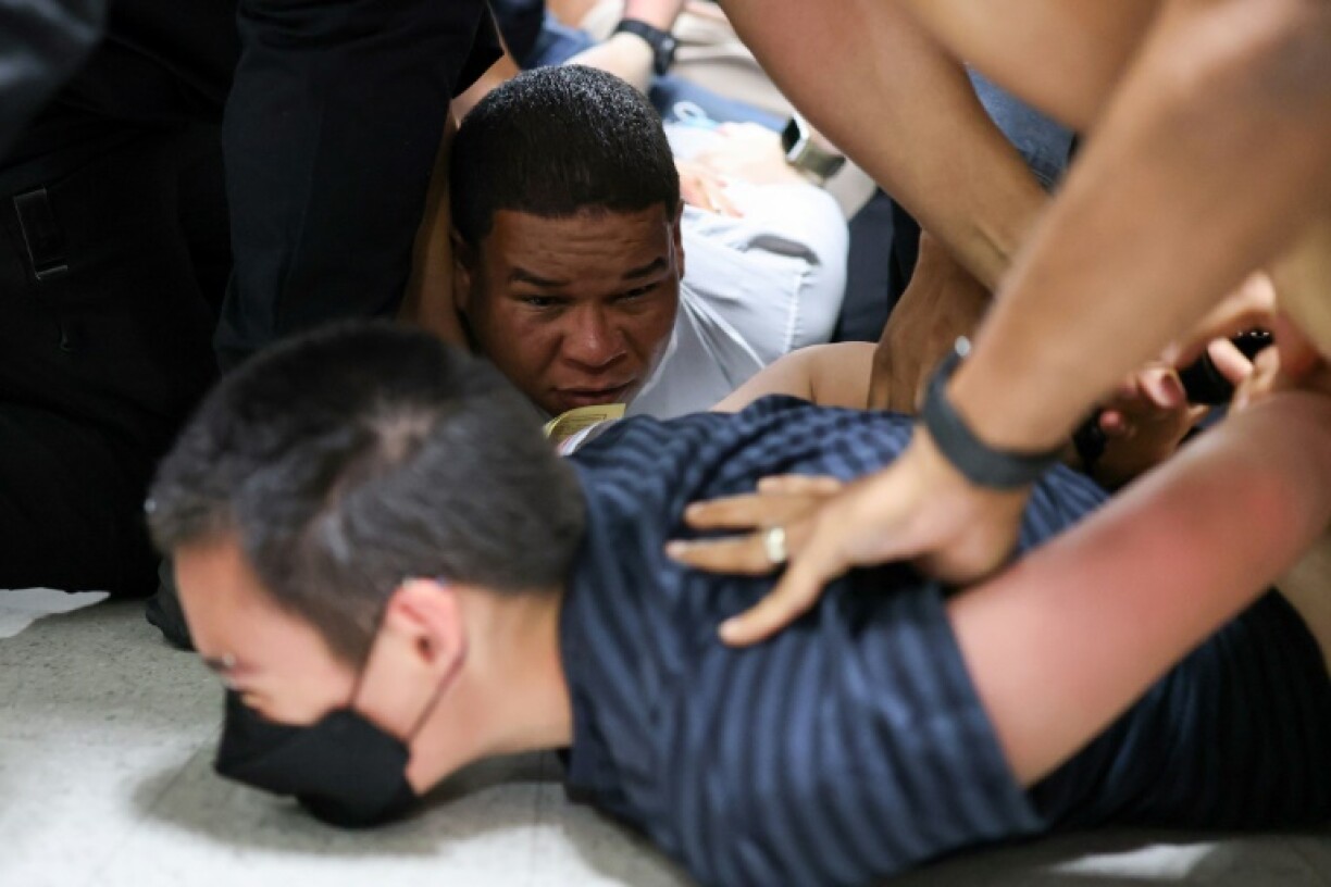 Two migrants are forcefully detained by US Immigration and Customs Enforcement agents in the hallways of immigration court in New York City after appearing for an appointment with immigration authorities