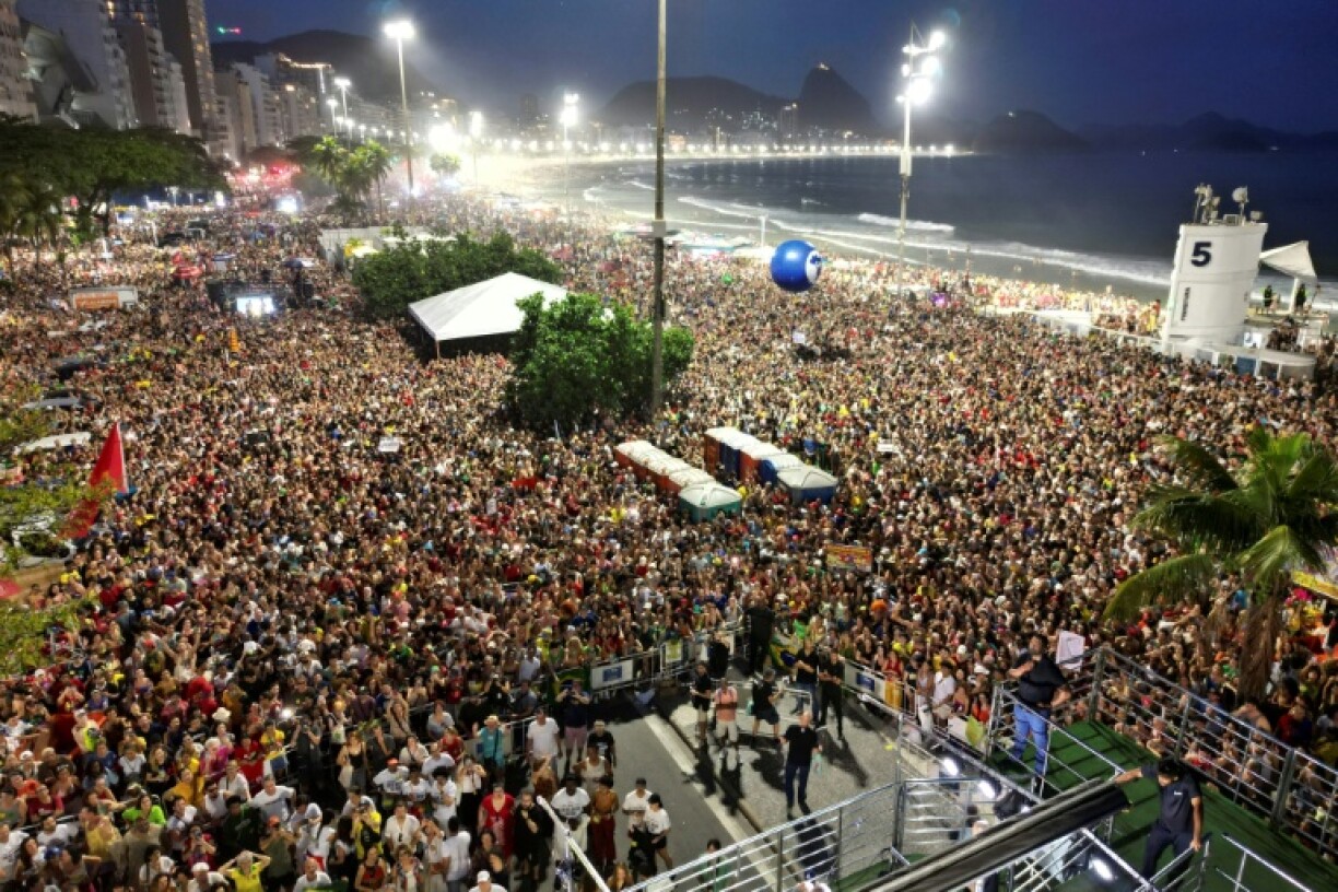 Tens of thousands sing along at a 'musical protest' on Copacabana Beach against a series of controversial laws passed in Congress