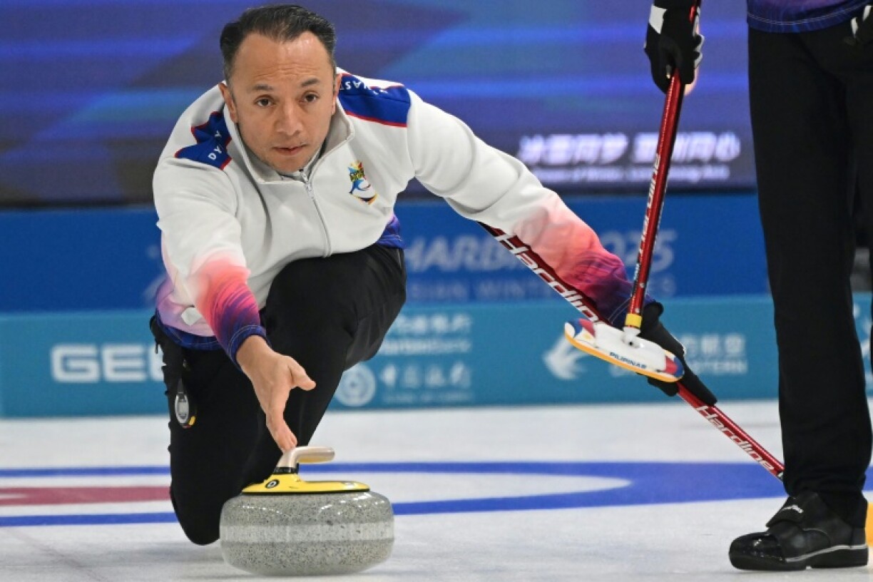 Philippines curler Alan Frei delivers a stone during curling round robin match against Kazakhstan at Asian Winter Games in Harbin