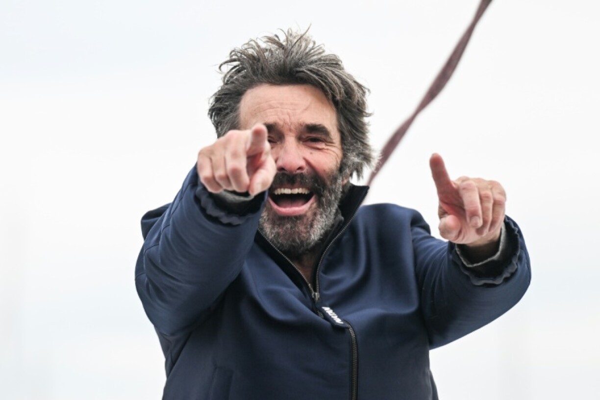 Denis Van Weynbergh celebrating as he finishes the Vendee Globe
