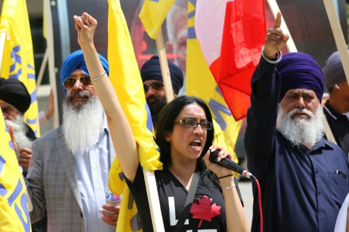 A woman holds up her fist during a protest against Indian Prime Minister Narendra Modi in Calgary, Alberta, as he attended the Group of Seven summit in the Canadian province