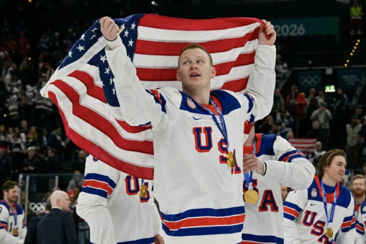 Brady Tkachuk and his US teammates celebrate with their gold medals following the men's ice hockey final at the Milano Santagiulia Ice Hockey Arena during the Milano Cortina 2026 Winter Olympic Games in Milan, on February 22, 2026