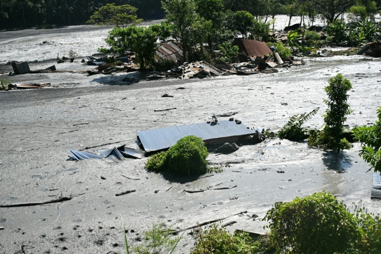 Damaged houses lie partially submerged in sludge along the banks of the Budhi Gandaki river after floods in Nepal