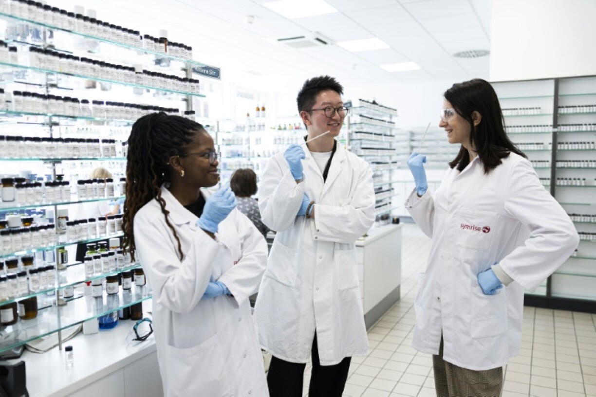 Junior perfumers Attiya Setai, Shangyun Lyu and Alicia de Benito Cassado hold smell strips used to evaluate fragrances