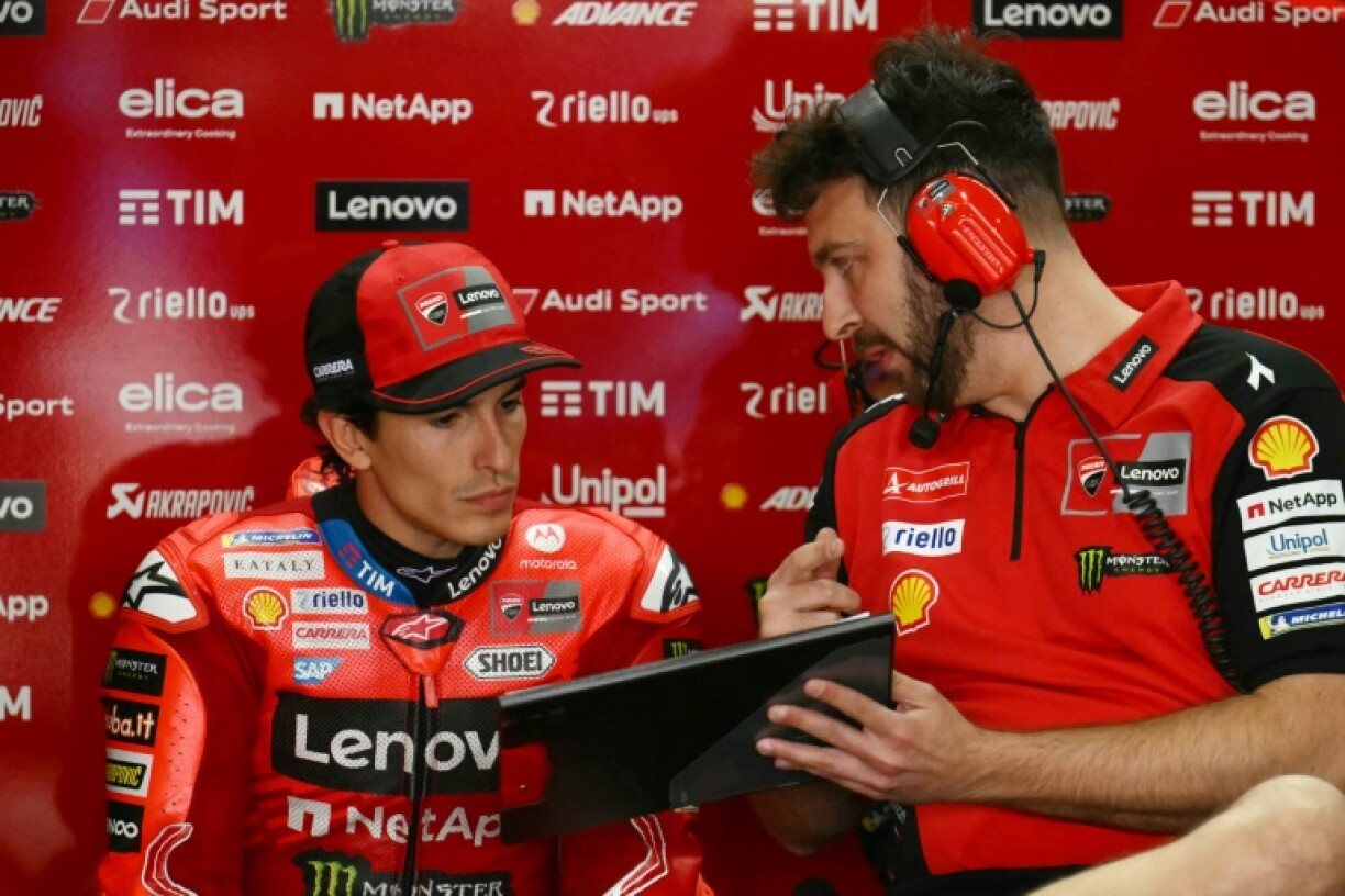 Textbook performance: Marc Marquez talks to a Ducati engineer in the pits at the Argentina MotoGP