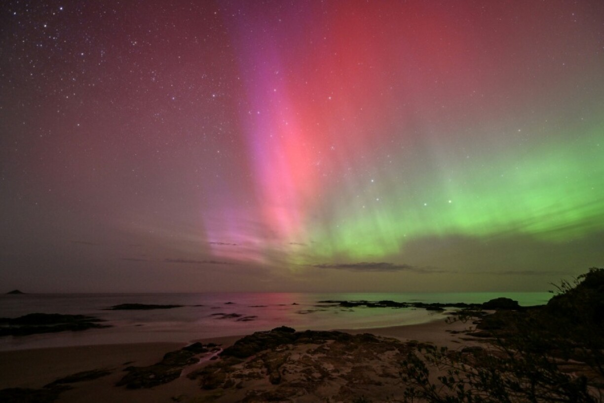 The Aurora Australis, also known as the Southern Lights, glows on the horizon over the waters of Brighton Beach in Dunedin, New Zealand early on November 13, 2025