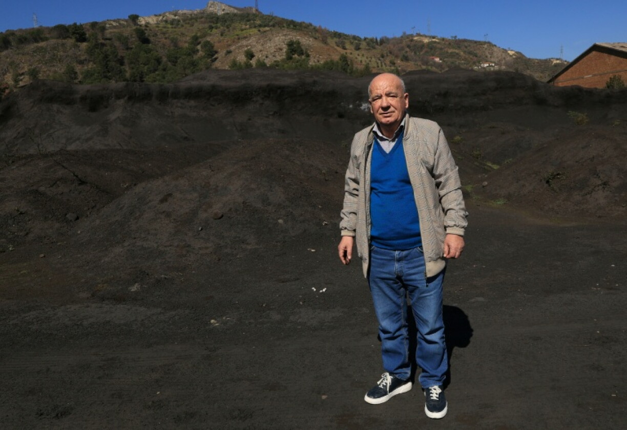 Environmental expert Beqir Kila walks through an open-air waste dump from the Elbasan steel plants