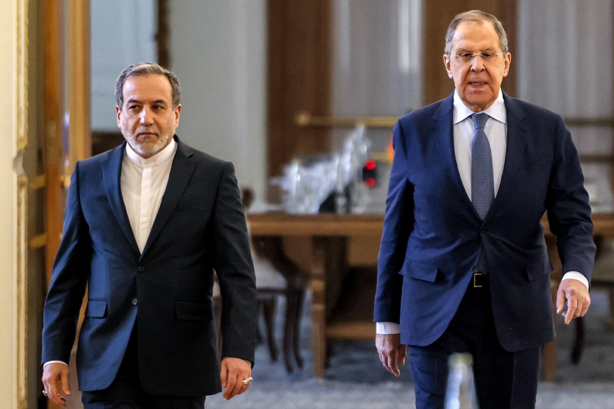 Iran's Foreign Minister Abbas Araghchi (L) and Russia's Foreign Minister Sergei Lavrov walk together after joint press conference at the foreign ministry headquarters in Tehran on February 25, 2025.