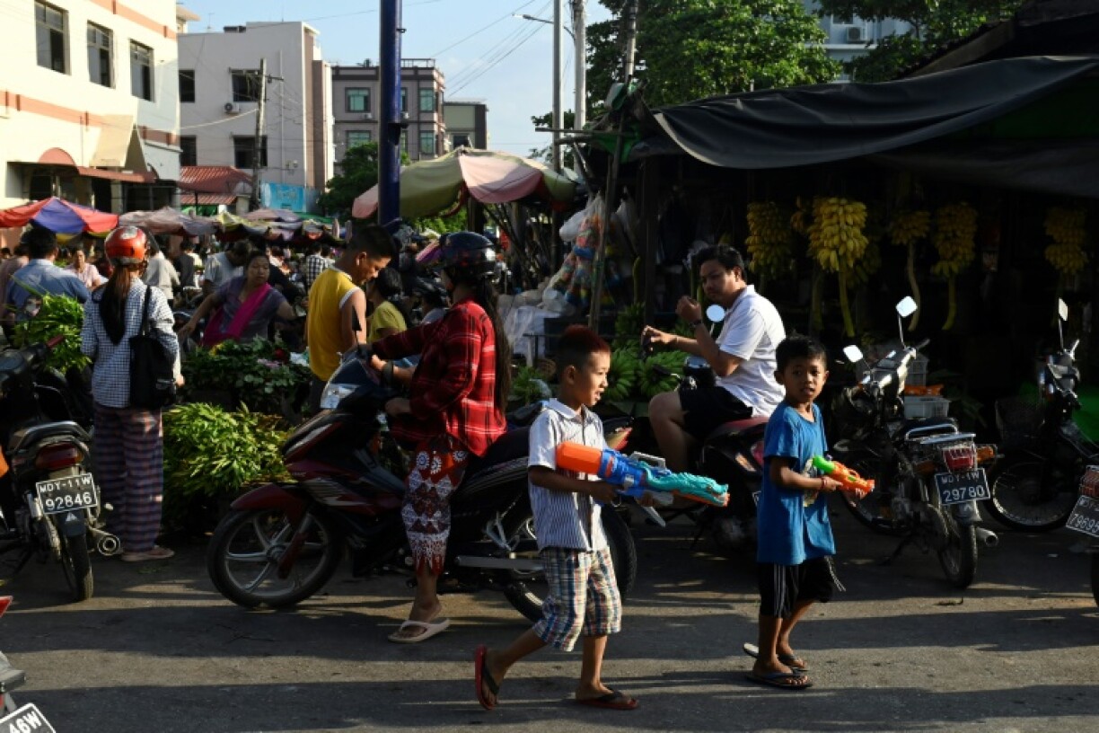 Children in Mandalay play with water guns during Myanmar's New Year water festival, locally known as Thingyan