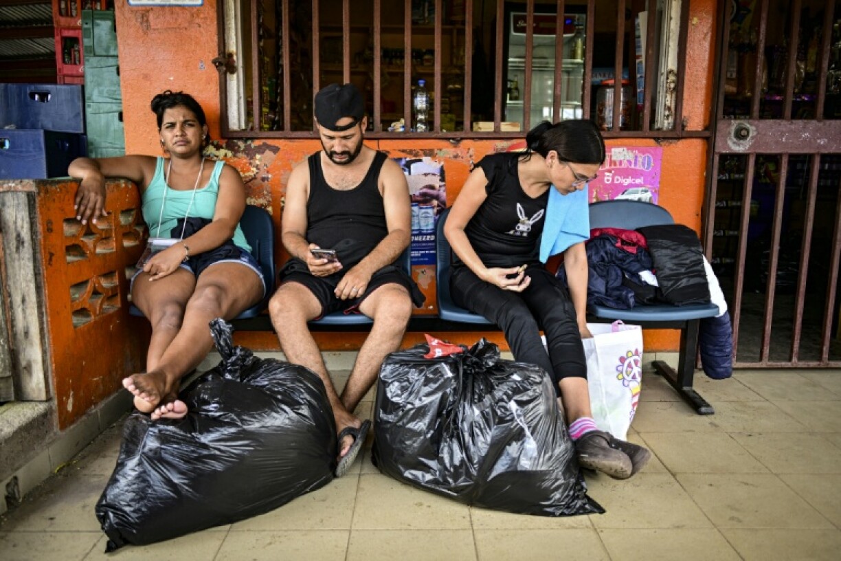 Migrants trying to go home to South America wait to board a boat in Panama
