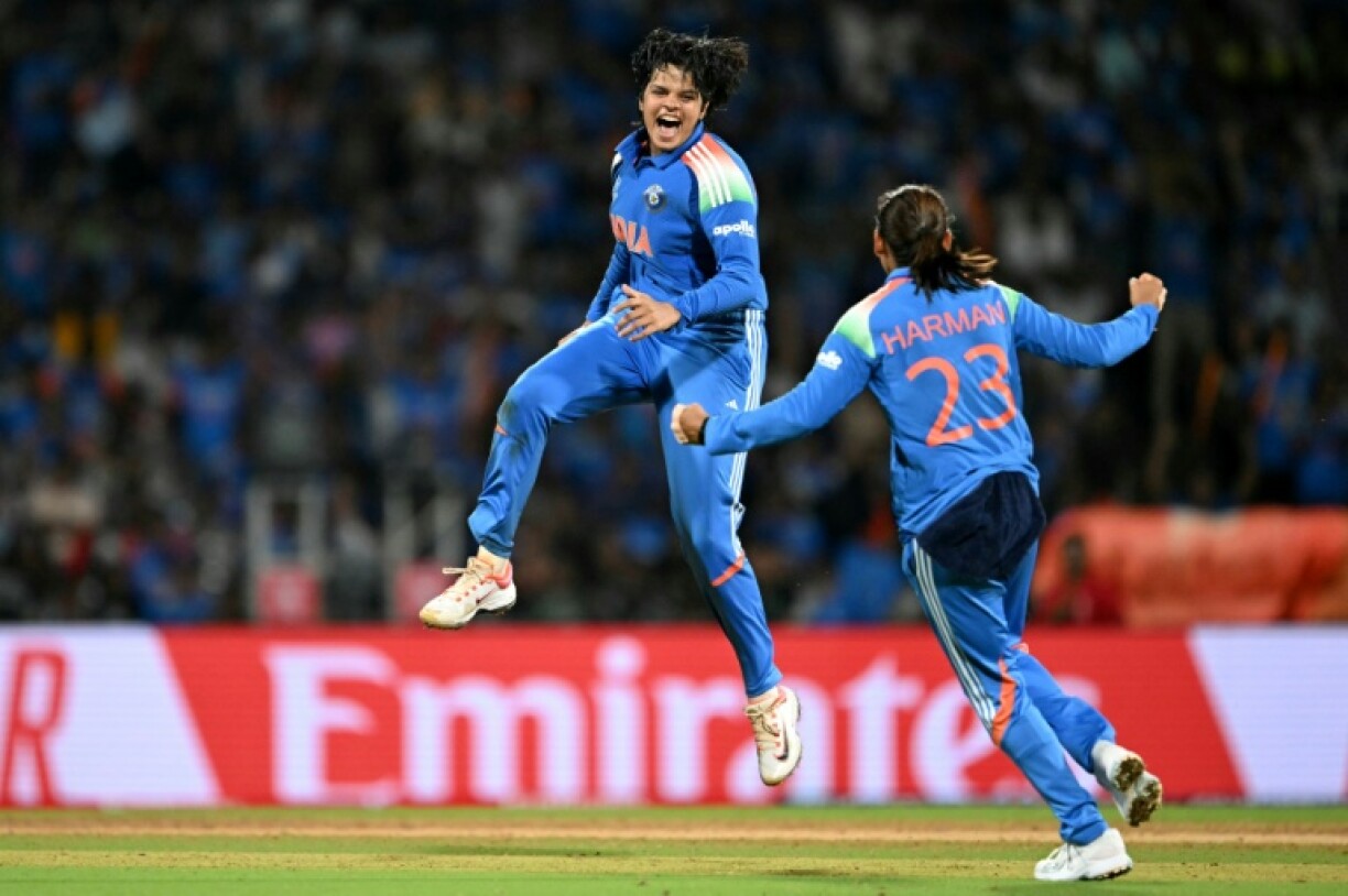 India's Shafali Verma celebrates with her team captain Harmanpreet Kaur in the final