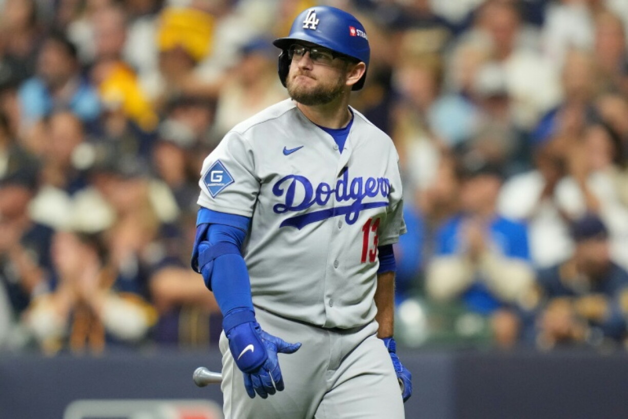 Max Muncy of the Los Angeles Dodgers walks to the dugout after striking out in the team's loss to the Milwaukee Brewers in game one of the National League Championship Series