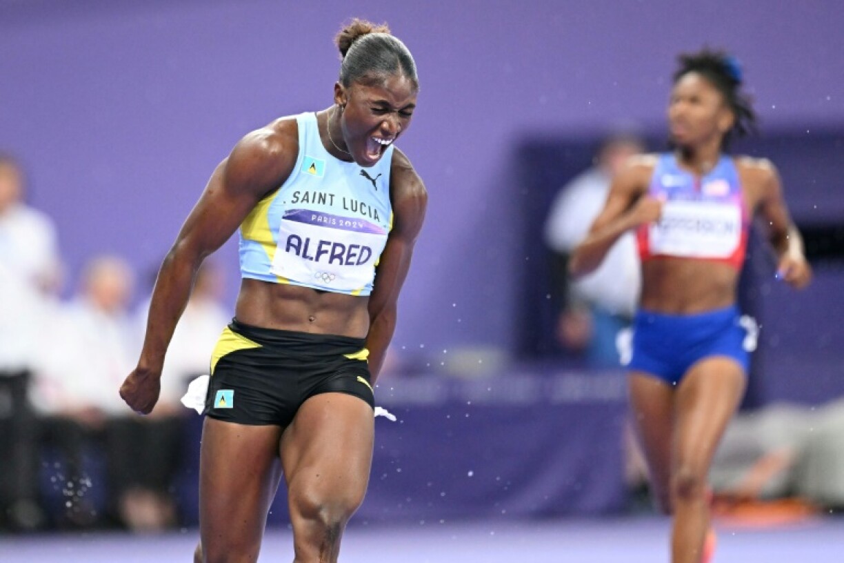 Saint Lucia's Julien Alfred celebrates after winning the women's 100m at the Paris Olympics