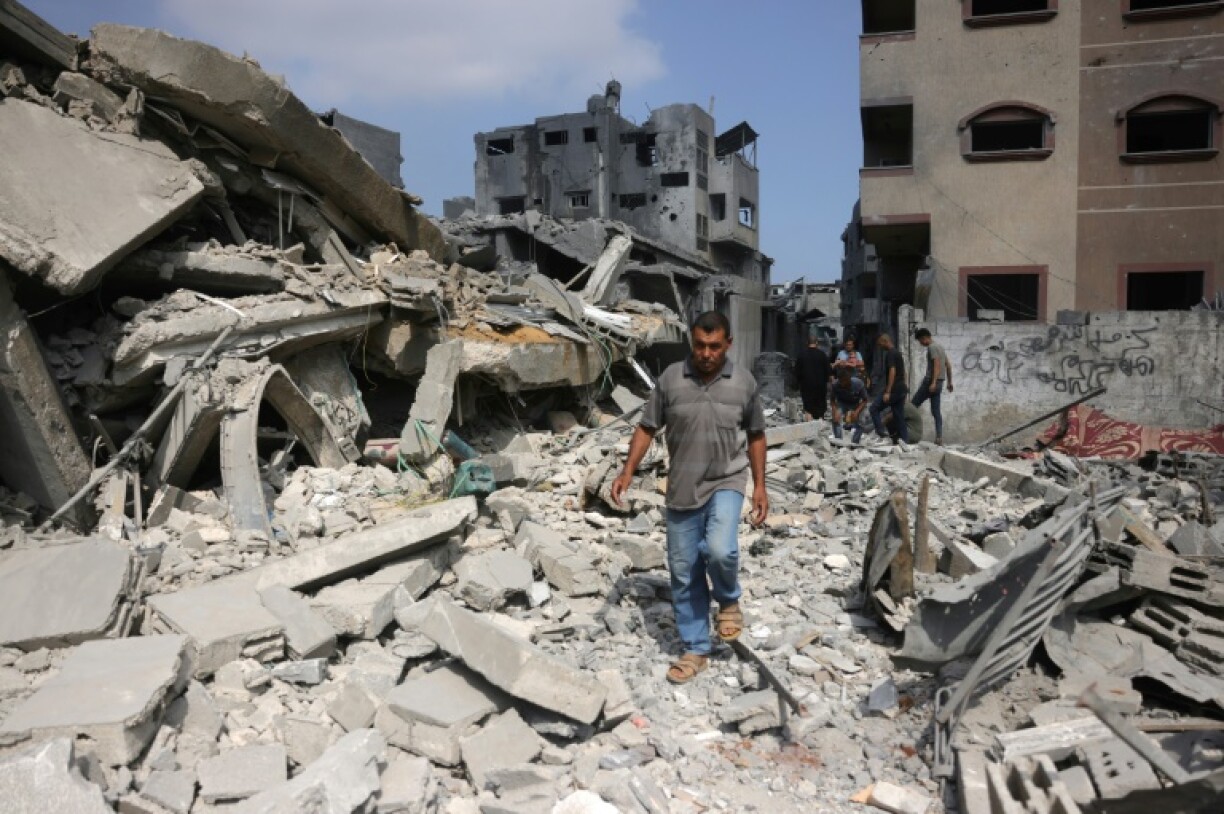 A Palestinian man walks beside the rubble of a house hit by overnight Israeli strikes in Jabalia in the northern Gaza Strip on Monday