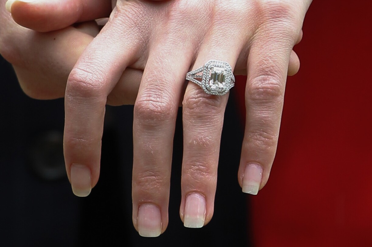 Countess Stéphanie showing off her emerald cut diamond engagement ring on the day of the announcement.