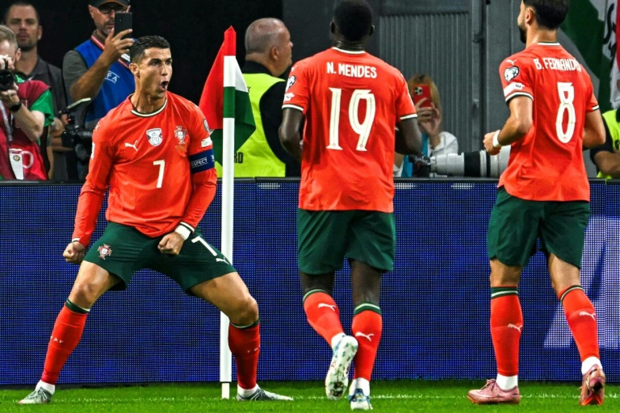 Cristiano Ronaldo (L) extended his international goal-scoring record