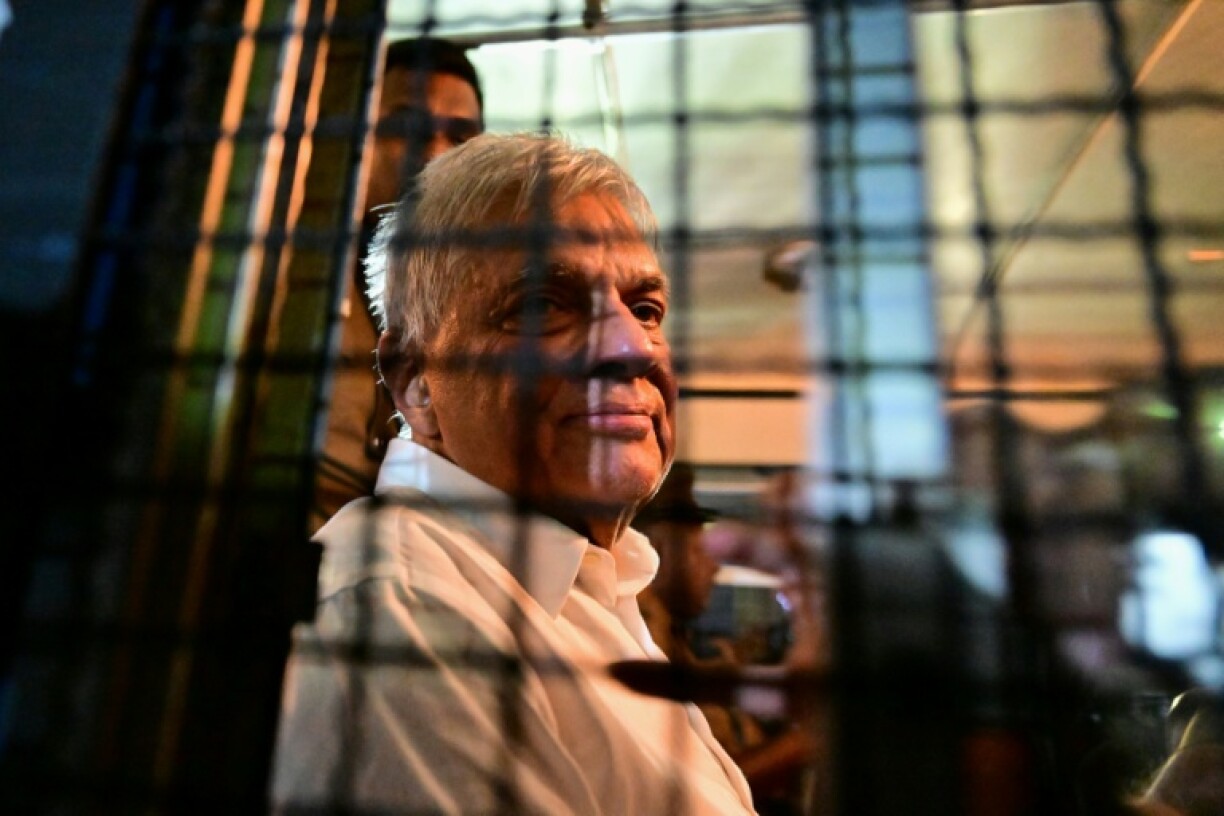 Sri Lanka's former president Ranil Wickremesinghe looks on as he sits in a prison bus in Colombo