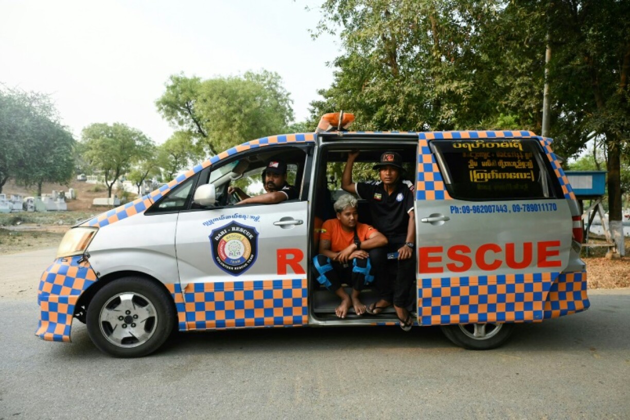 Rescue workers are seen in their vehicle after transporting the body of a victim for cremation near Mandalay, Myanmar