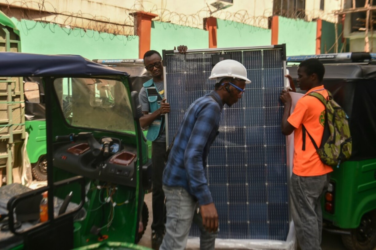 Workers at start-up company NEEV Salone assemble solar-powered tricycles in Freetown