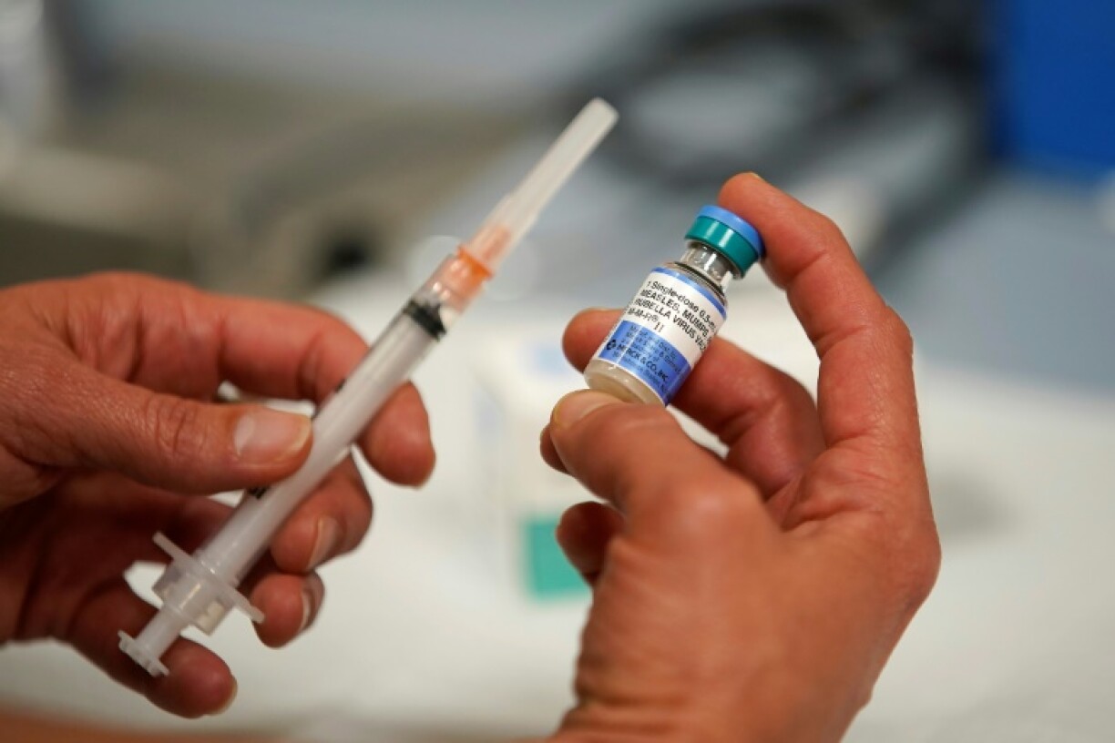A one dose bottle of measles, mumps and rubella virus vaccine, made by MERCK, is held up at the Salt Lake County Health Department on April 26, 2019 in Salt Lake City, Utah