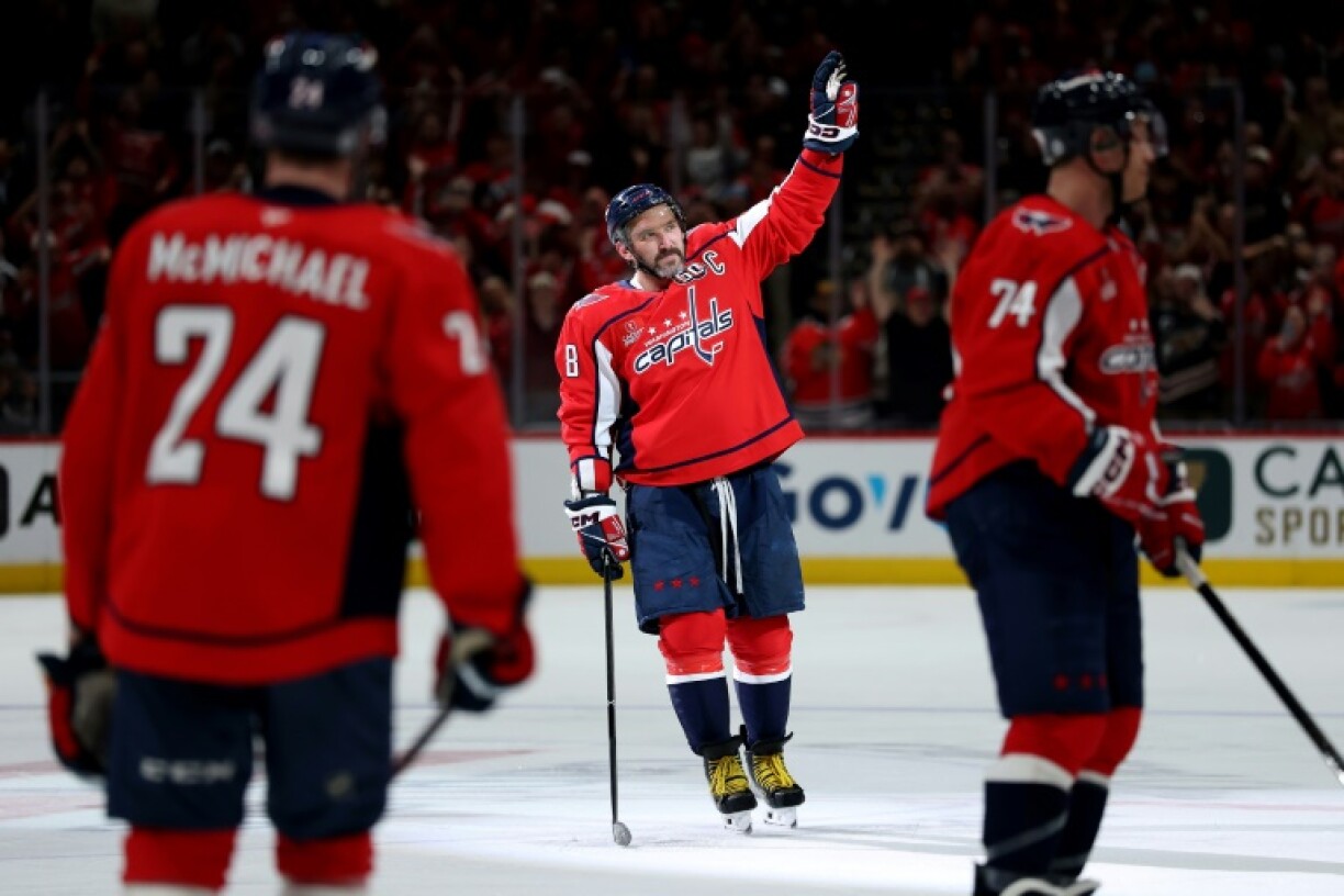 Alex Ovechkin of the Washington Capitals celebrates with teammates after scoring his 894th career goal to tie Wayne Gretzky's all-time NHL record