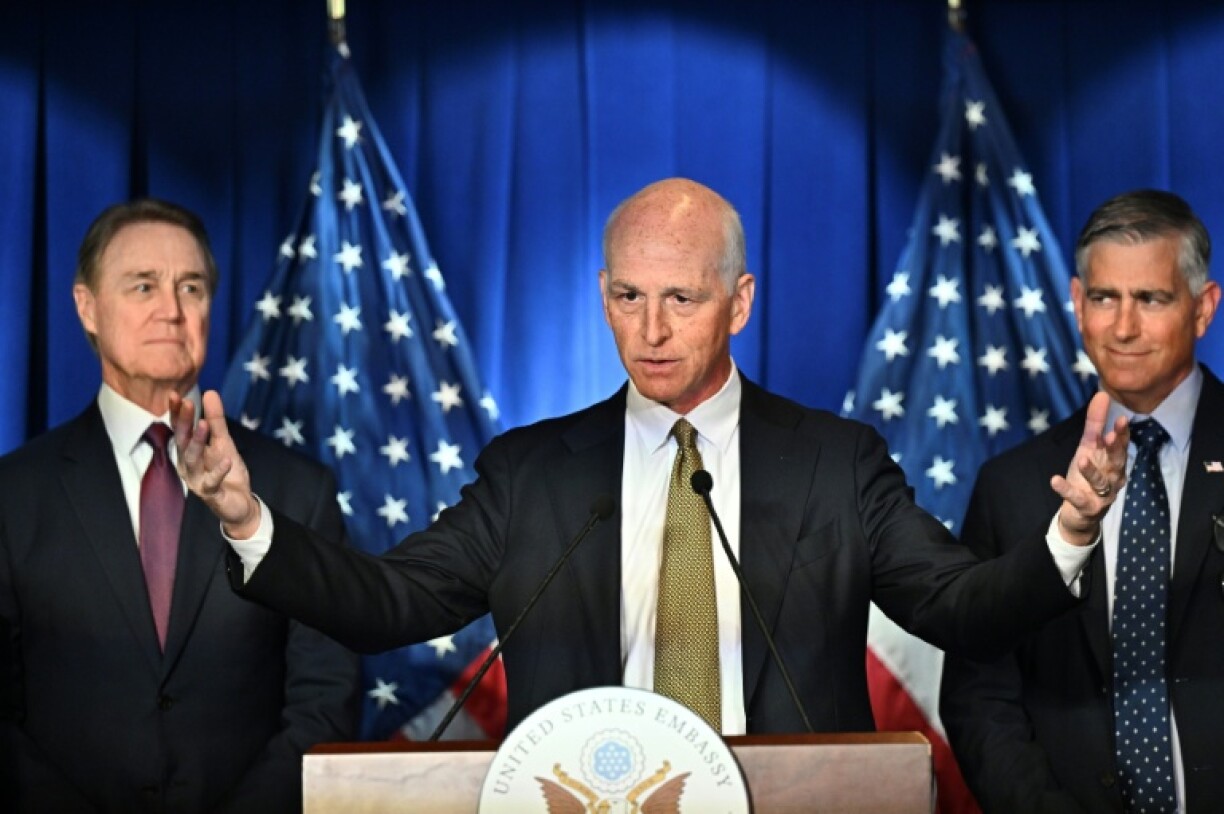 US Representative Adam Smith, flanked by US Ambassador to China David Perdue (left) and Michael Baumgartner, Republican member of House Foreign Affairs Committee during a press conference at the US embassy in Beijing