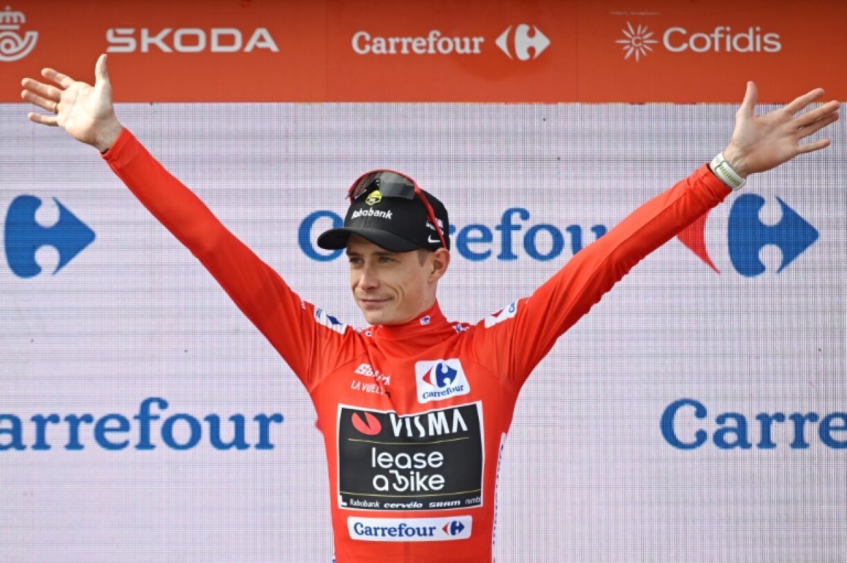 Danish rider Jonas Vingegaard celebrates on the podium wearing the leader's red jersey after stage 10 of the Vuelta a Espana
