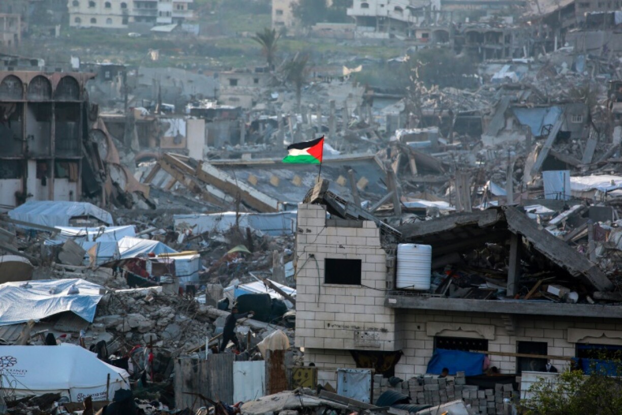 A Palestinian flag flutters amid the ruins of buildings in Beit Lahia in the northern Gaza Strip on March 4
