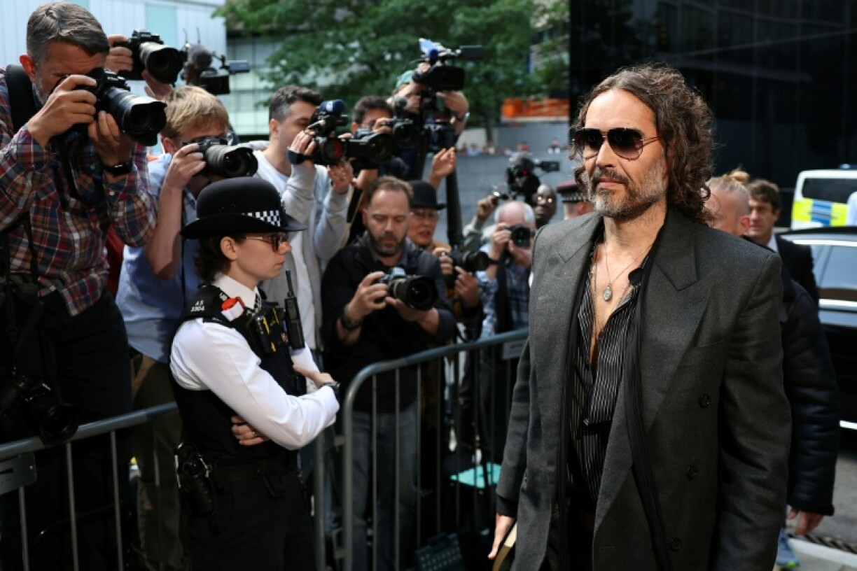 British comedian and actor Russell Brand arrives at Southwark Crown Court and was due to enter pleas for five sexual offence charges including rape and sexual assault
