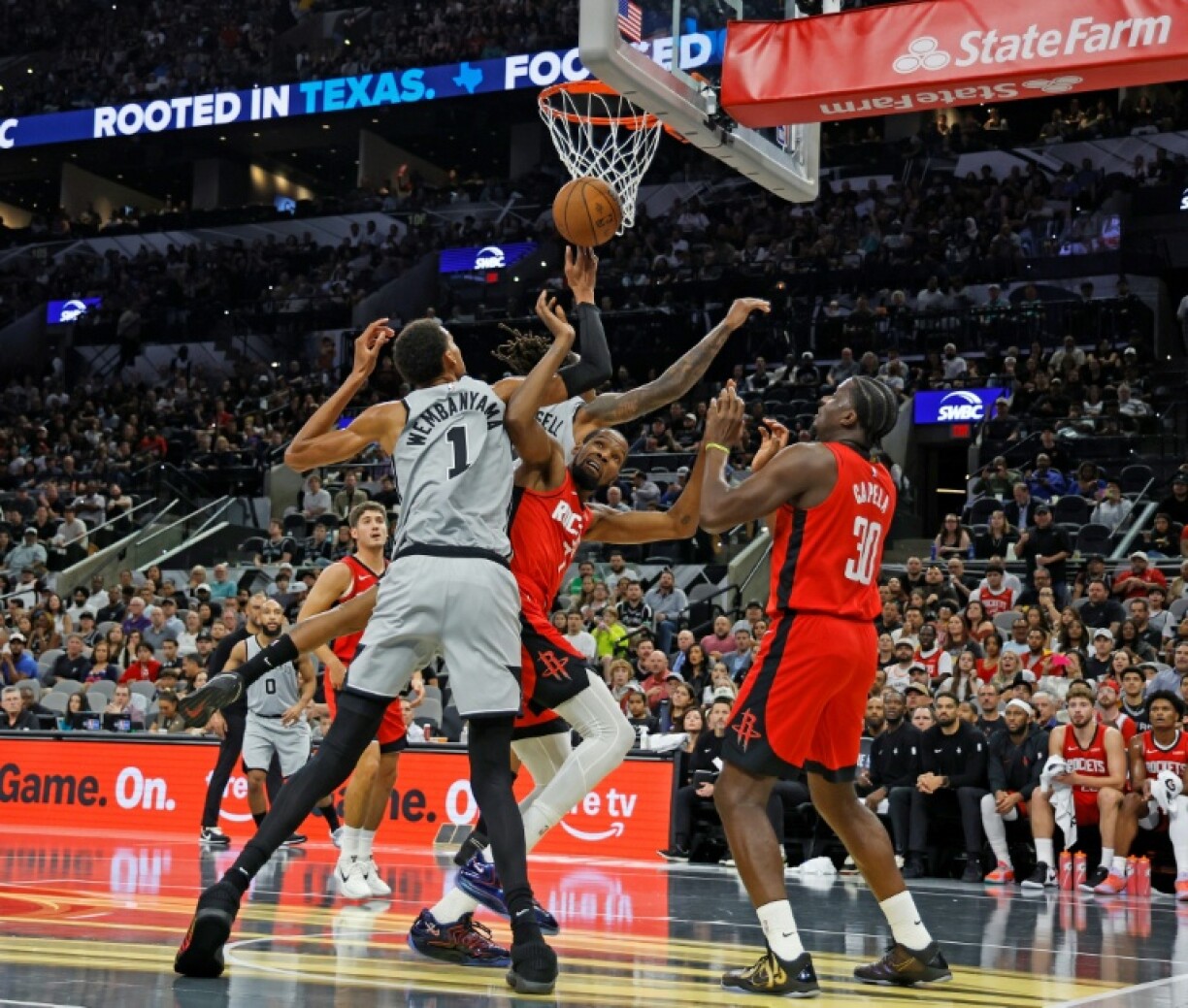 Victor Wembanyama of the San Antonio Spurs fights for a rebound with Kevin Durant in the Spurs' NBA victory over the Houston Rockets
