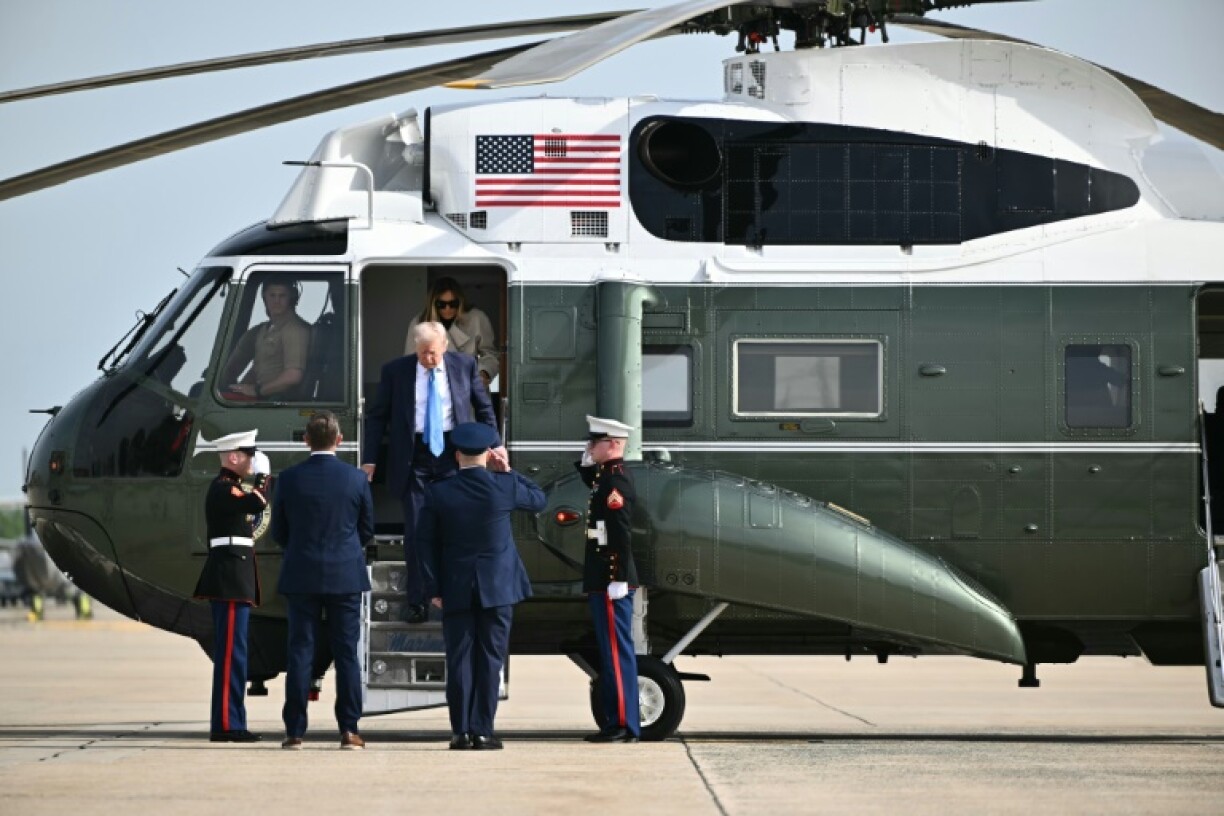 US President Donald Trump and First Lady Melania Trump step off Marine One upon arrival at Joint Base Andrews