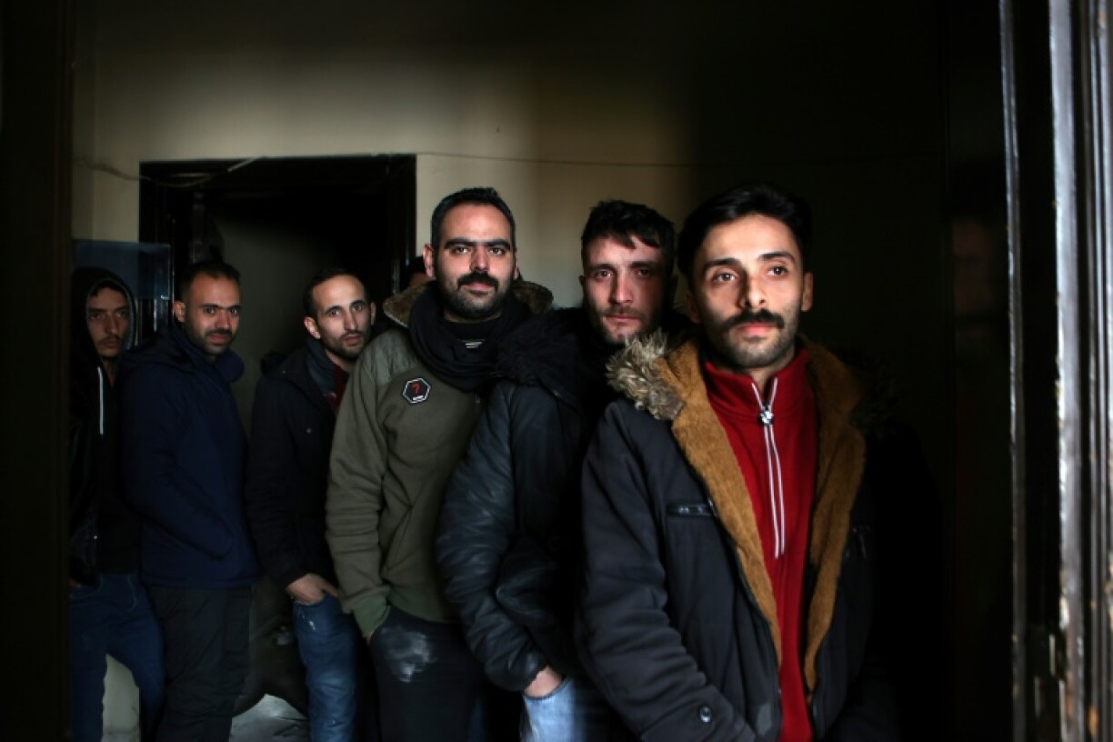 Soldiers and police who remained in Syria's commercial hub Aleppo when their commanders fled the rebel advance turn themselves in at a police station in the city.