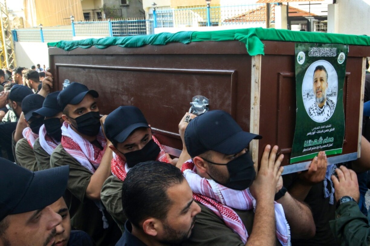 Mourners carry the casket of slain Hamas commander Hassan Farhat, in Lebanon's port of Sidon