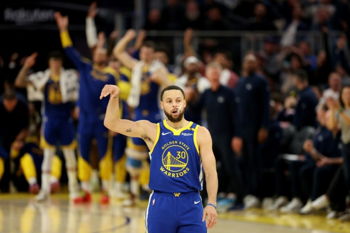 Stephen Curry celebrates after closing in on 4,000 career three-pointers in Golden State's victory over Portland