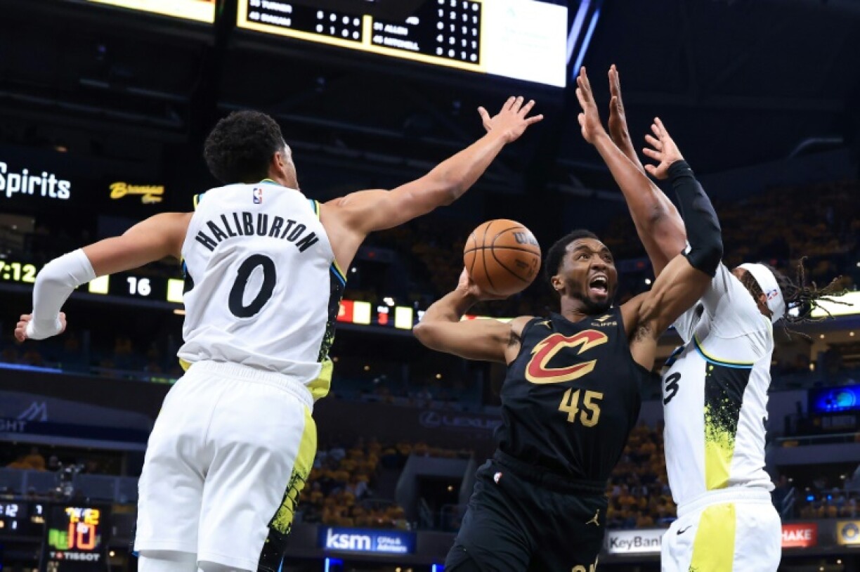 Donovan Mitchell of the Cleveland Cavaliers takes a shot against Tyrese Haliburton and Myles Turner in the Cavaliers' victory over the Indiana Pacers in game three of their NBA playoff series
