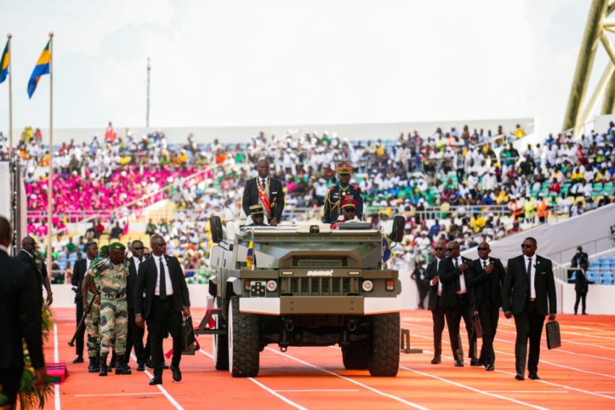 President Oligui touring a packed stadium north of the capital Libreville on the back of a white, open-roof car