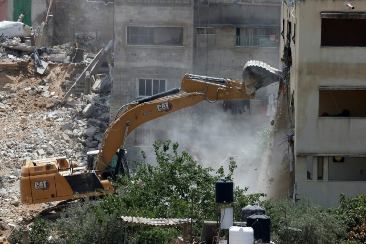 An Israeli military bulldozer demolishes a home at the Nur Shams Palestinian refugee camp in the Israeli occupied West Bank on June 23, 2025