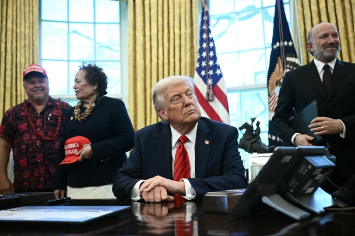 US President Donald Trump and Commerce Secretary Howard Lutnick (R) look on before Trump signed a proclamation expanding fishing rights in the Pacific islands in the Oval Office of the White House in Washington, DC, on April 17, 2025.