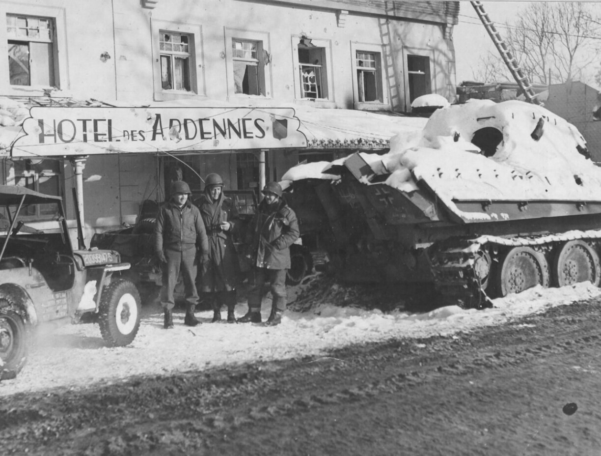 American soldiers beside a German tank Pz. Kpfw. V Panther during the Battle of the Bulge seen here in Echternach on the road to the Ardennes Belgium.