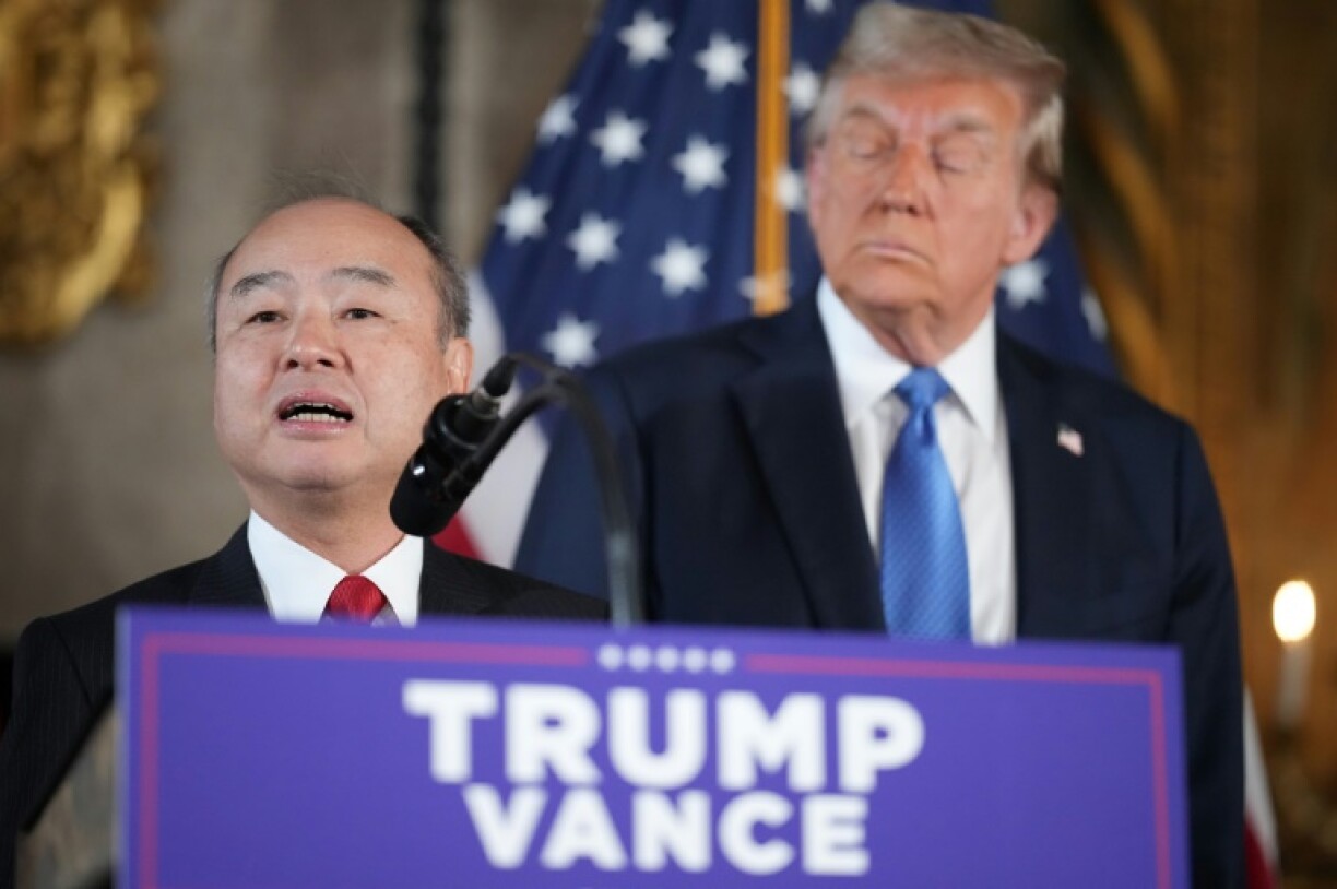 SoftBank CEO Masayoshi Son delivers remarks while US President-elect Donald Trump looks on at Mar-a-Lago in Florida on December 16, 2024