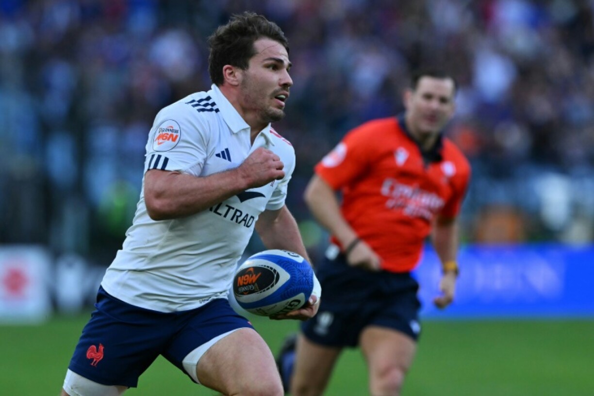 On the run: France captain Antoine Dupont goes in to score one of his side's 11 tries in a 73-24 Six Nations thrashing of Italy in Rome