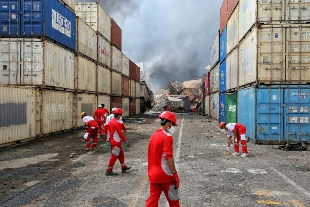 Rescuers work near toppled containers at the port located near the Strait of Hormuz, in a photo provided by the Iranian Red Crescent