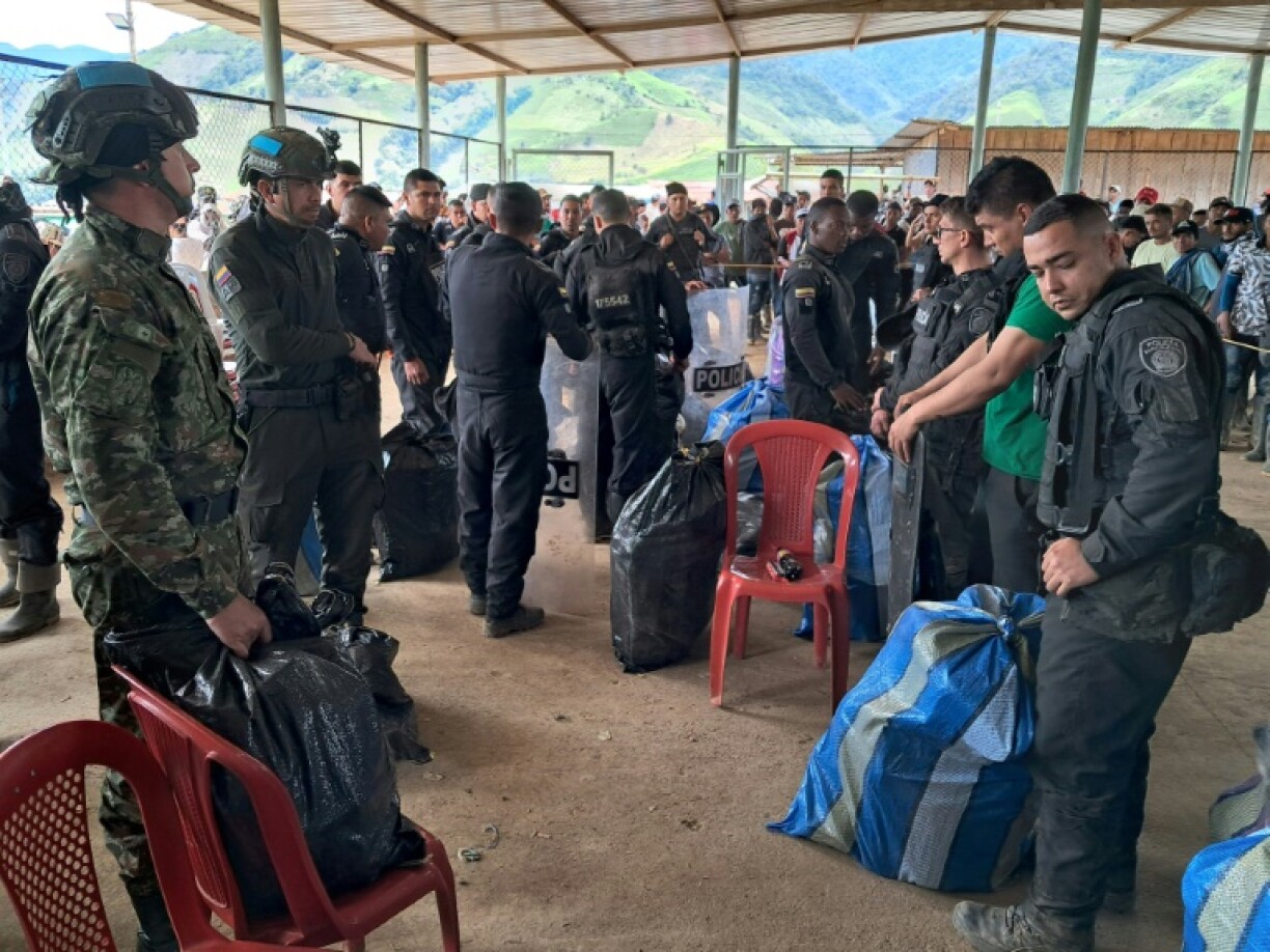 Security personnel taken captive by dissident members of the FARC rebel group wait for their transfer after being released in El Plateado, Cauca department, Colombia
