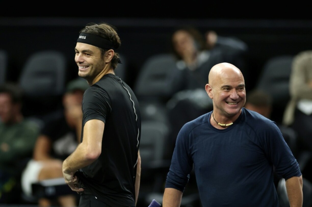 Team World's Taylor Fritz and captain Andre Agassi share a laugh during practice for the Laver Cup