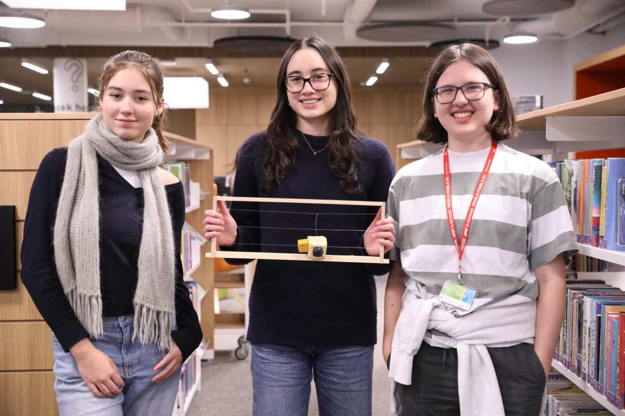 Daniela, Vivian and Camille in ISL Upper School Library with their prototype.