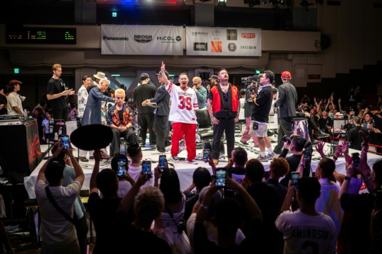 Barbers react after competing in the World Barber Classic in Tokyo, part of a bid to bring back young male clients to shops