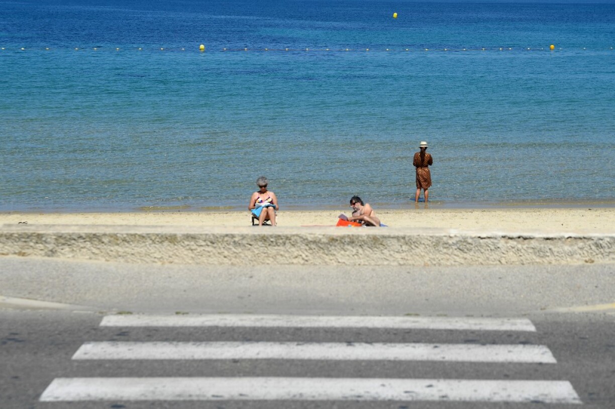 People are seen on a beach in Six-Fours-les-Plages, southern France, on May 27, 2021.