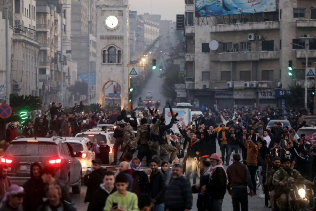 Residents take to the streets of Hama to welcome the rebels.