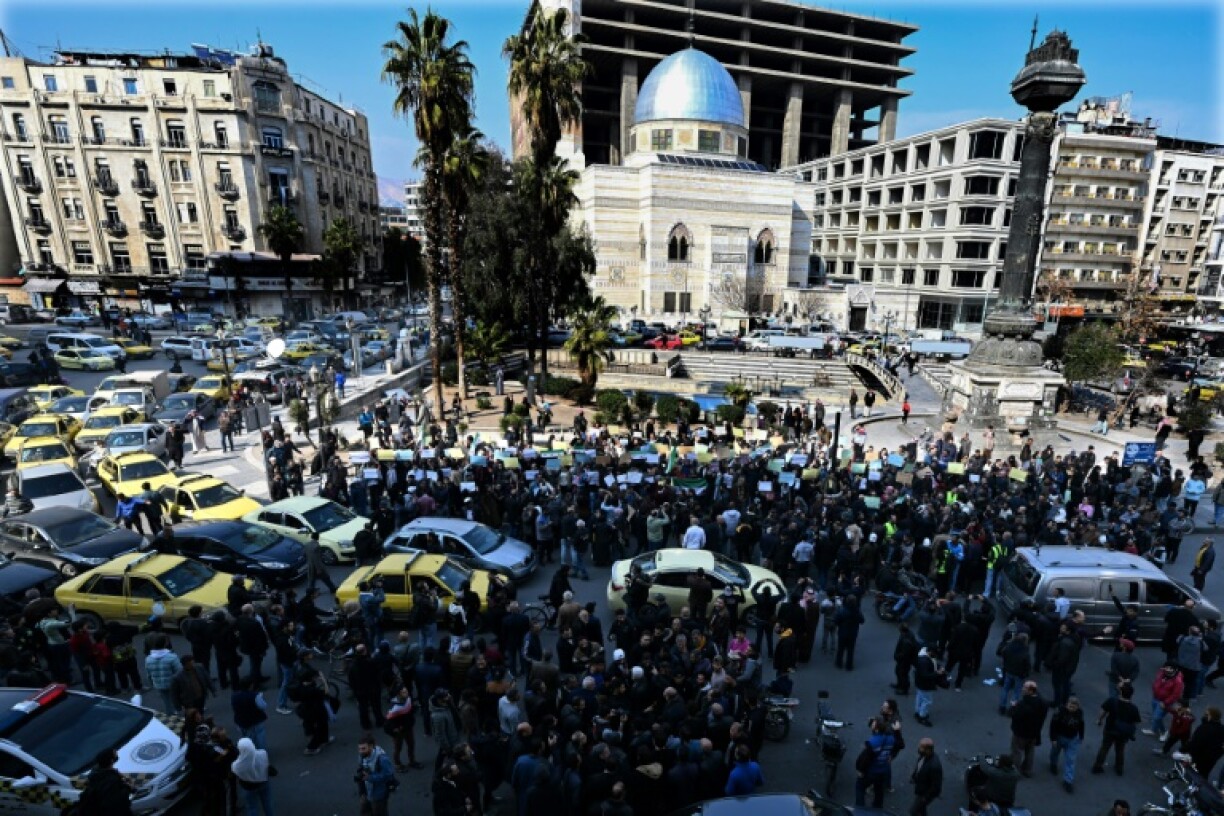 People gather at al-Marjeh square in Damascus for a rally called by Syrian activists