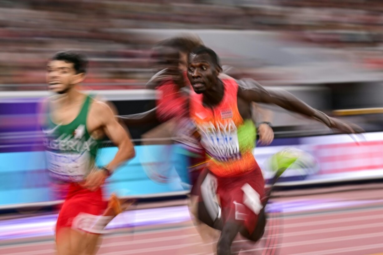 Kenya's Emmanuel Wanyonyi (R) wins the world men's 800m ahead of Algeria's Djamel Sedjati